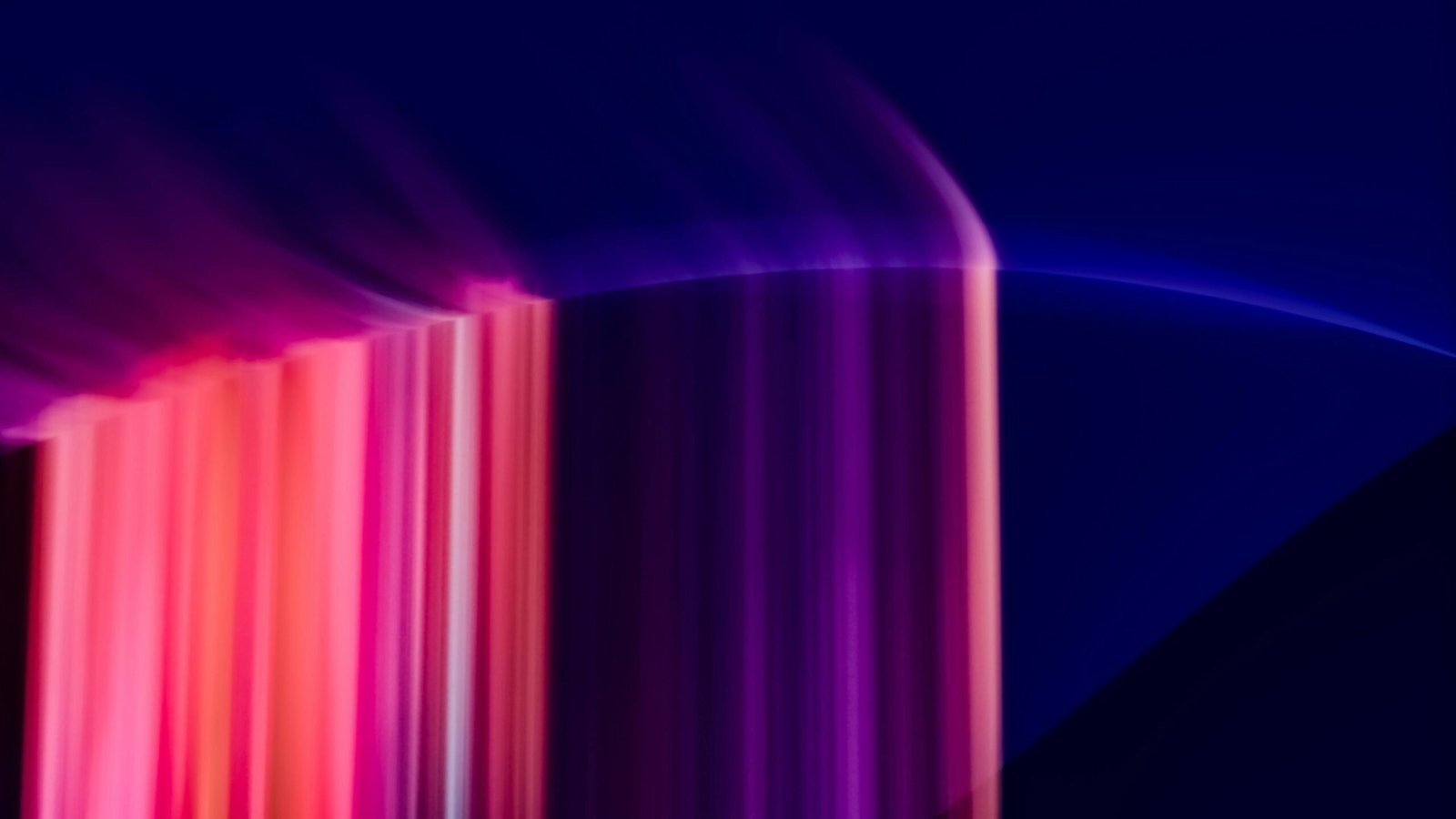 Dynamic abstract image with vibrant light streaks in purple and pink tones.